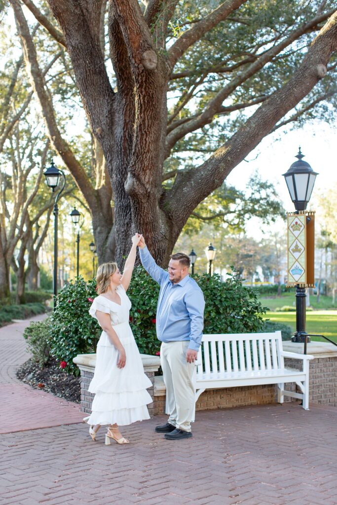 Guy twirls girl for their Disney Engagement Photos at Port Orleans Resort