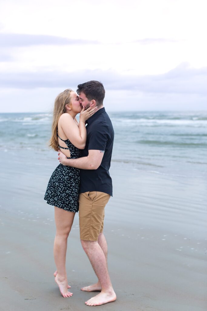 Couple kisses on beach after their proposal for their New Smyrna Beach Photos