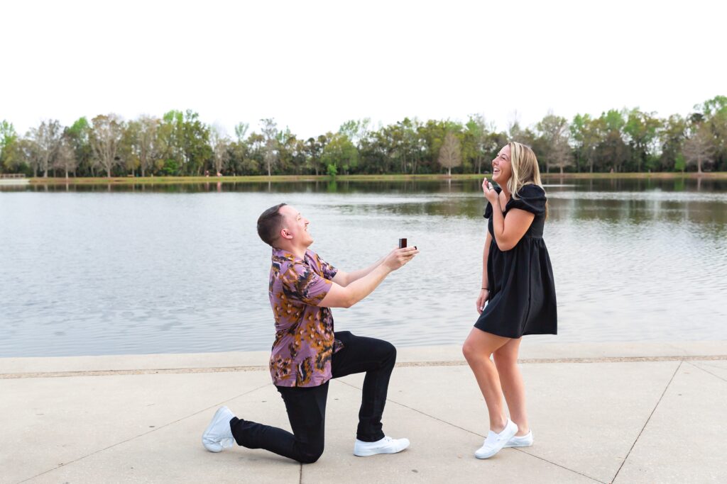 Guy proposes to girl in front of the water on Front Street in Celebration, Florida
