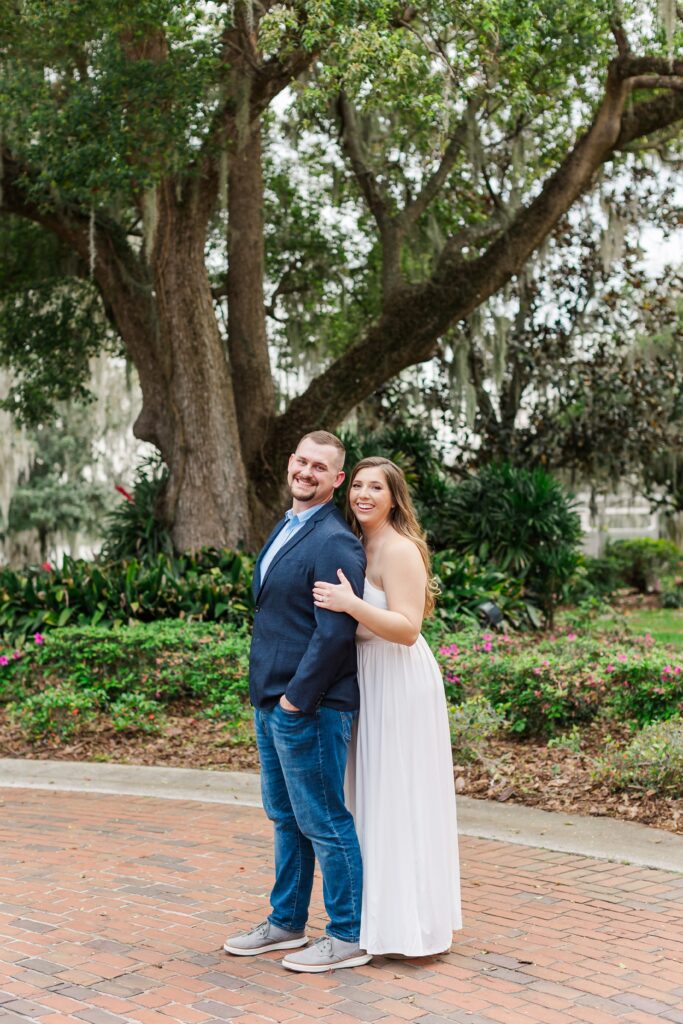Couple poses and laughs in front of Cypress Grove Estate House for their Orlando Engagement Photos at Cypress Grove Park in Orlando