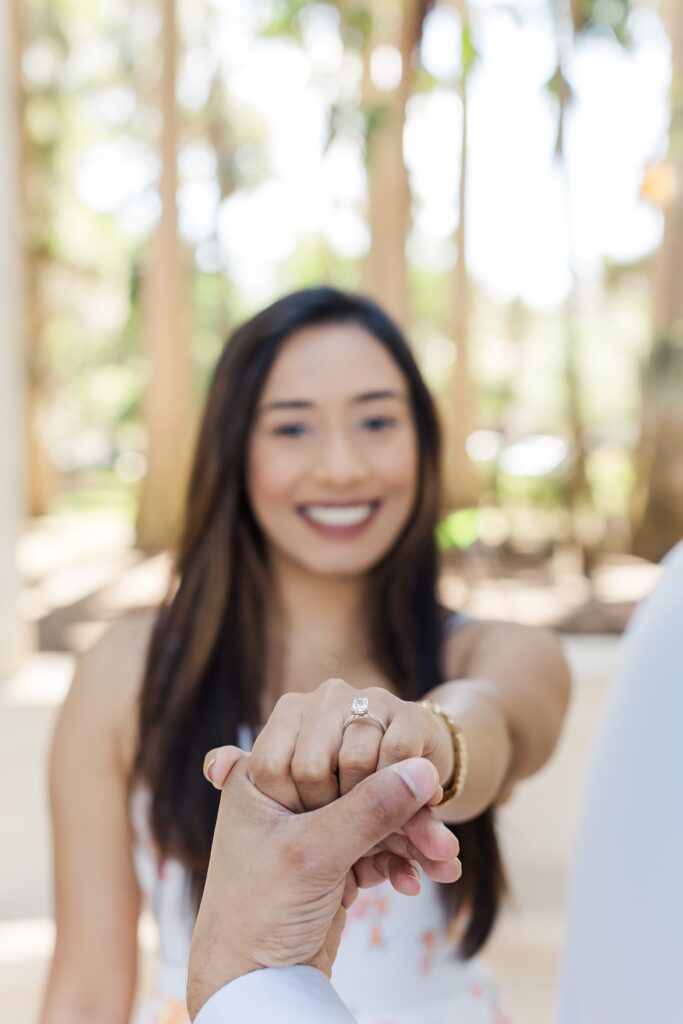 Girl shows off ring after guy proposes to her at Kraft Azalea Garden in Winter Park, FL
