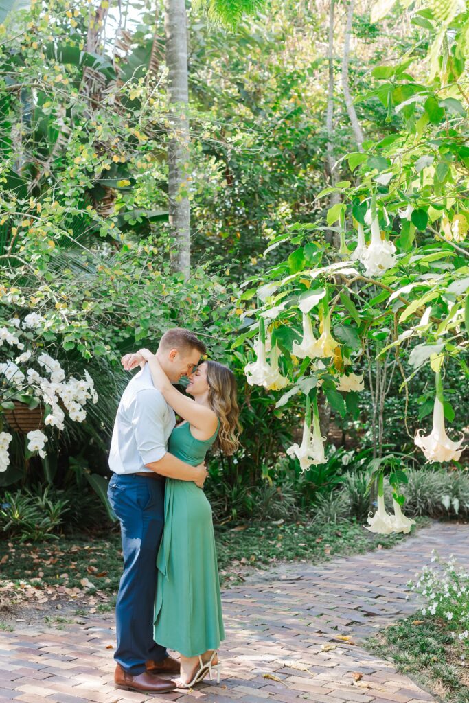 Couple hugs in the white garden after their proposal at Leu Gardens Orlando
