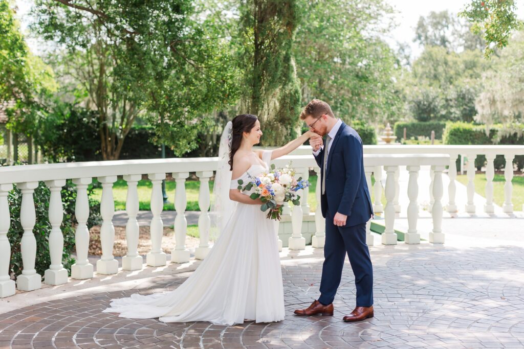 Groom kisses Bride's hand at their Leu Gardens Wedding in Orlando, Florida