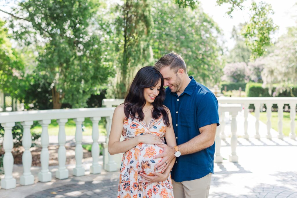 Couple poses for their Orlando Maternity Photos at Leu Gardens