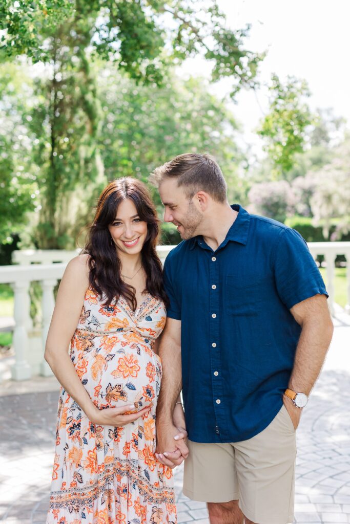 Couple smiles for their Orlando Maternity Photos at Leu Gardens