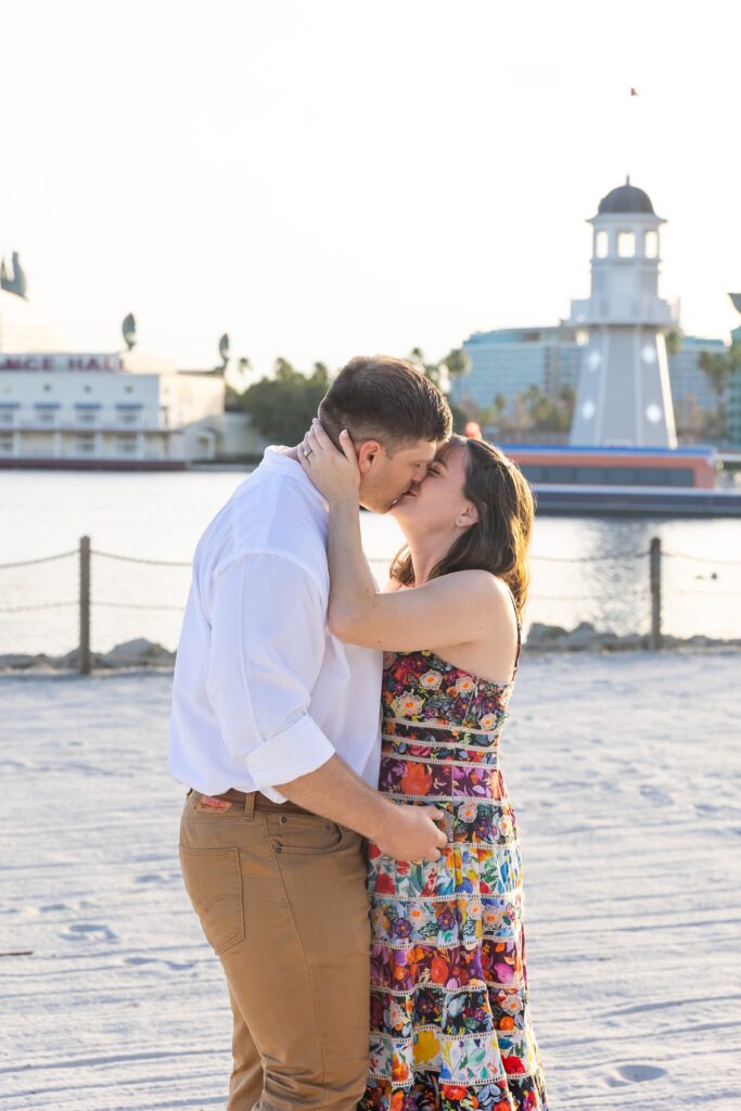 Couple hugs after their proposal on the beach at Disney's Beach Club Resort for their engagement photos