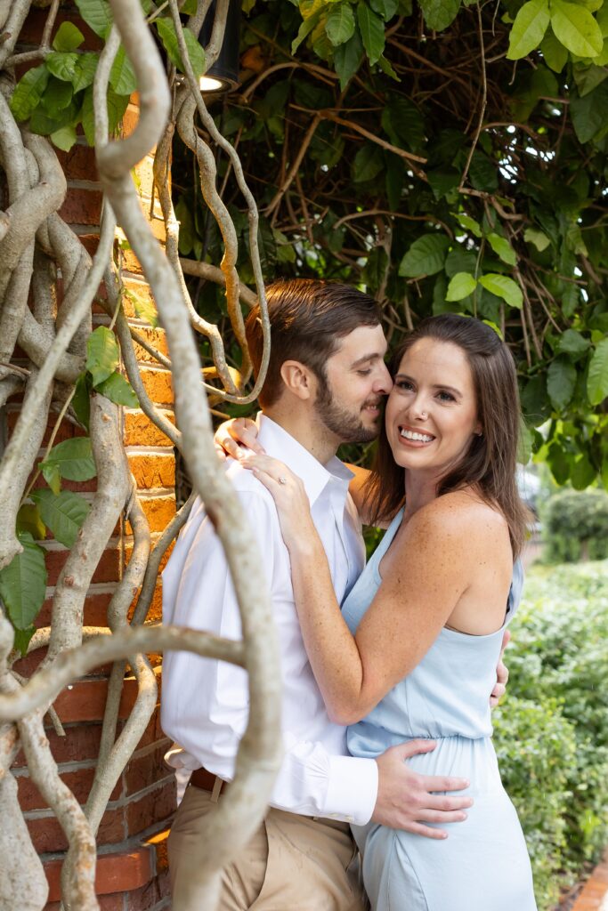 Couple poses for their engagement photos on Park Ave in Winter Park, Florida