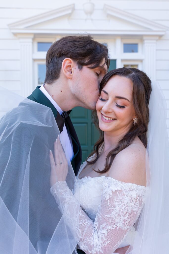 Groom kisses Bride's cheek at their micro wedding at Cypress Grove Estate House in Orlando, Florida