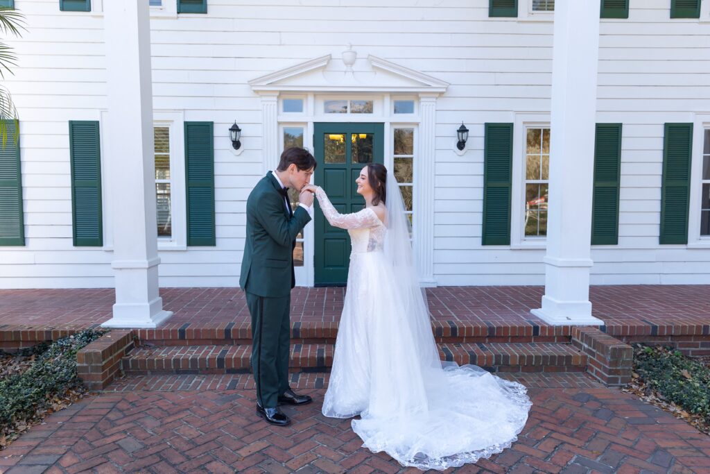 Groom kisses Bride's hand at their micro wedding at Cypress Grove Estate House in Orlando, Florida