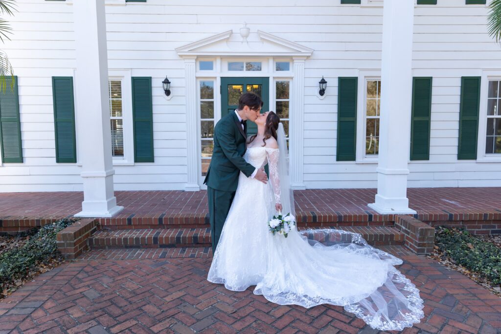 Groom kisses Bride at their micro wedding at Cypress Grove Estate House in Orlando, Florida