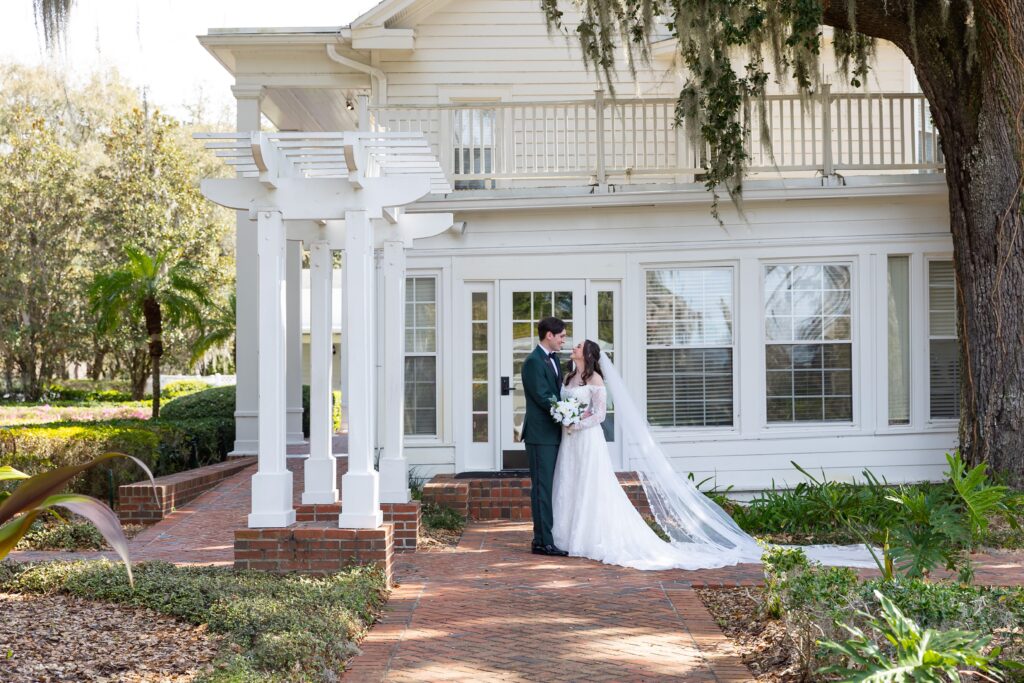 Bride and Groom look at each other and smile after their micro wedding at Cypress Grove Estate House in Orlando, Florida