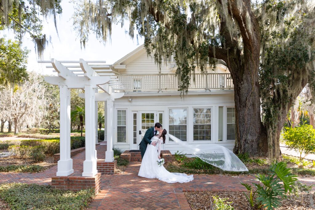 Groom dips and kisses Bride after their micro wedding at Cypress Grove Estate House in Orlando, Florida