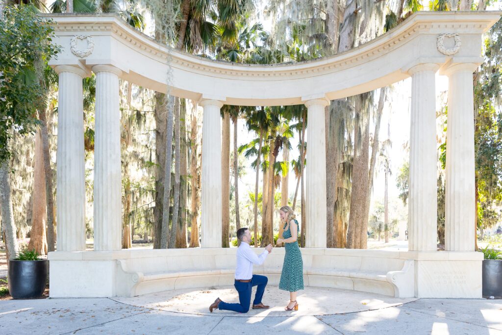 Guy proposes to girl in front of columns at Kraft Azalea Garden in Orlando, Florida