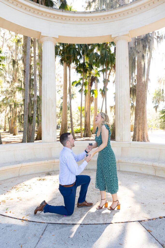 Guy proposes to girl in front of columns at Kraft Azalea Garden in Orlando, Florida