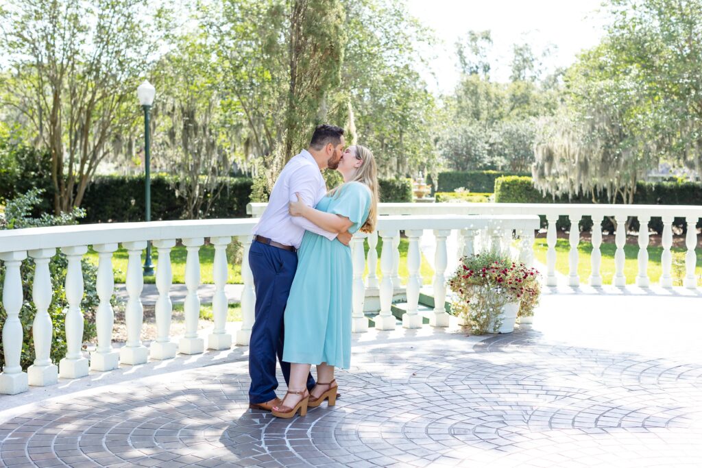 Couple kisses for their engagement photos at Leu Gardens in Orlando Florida