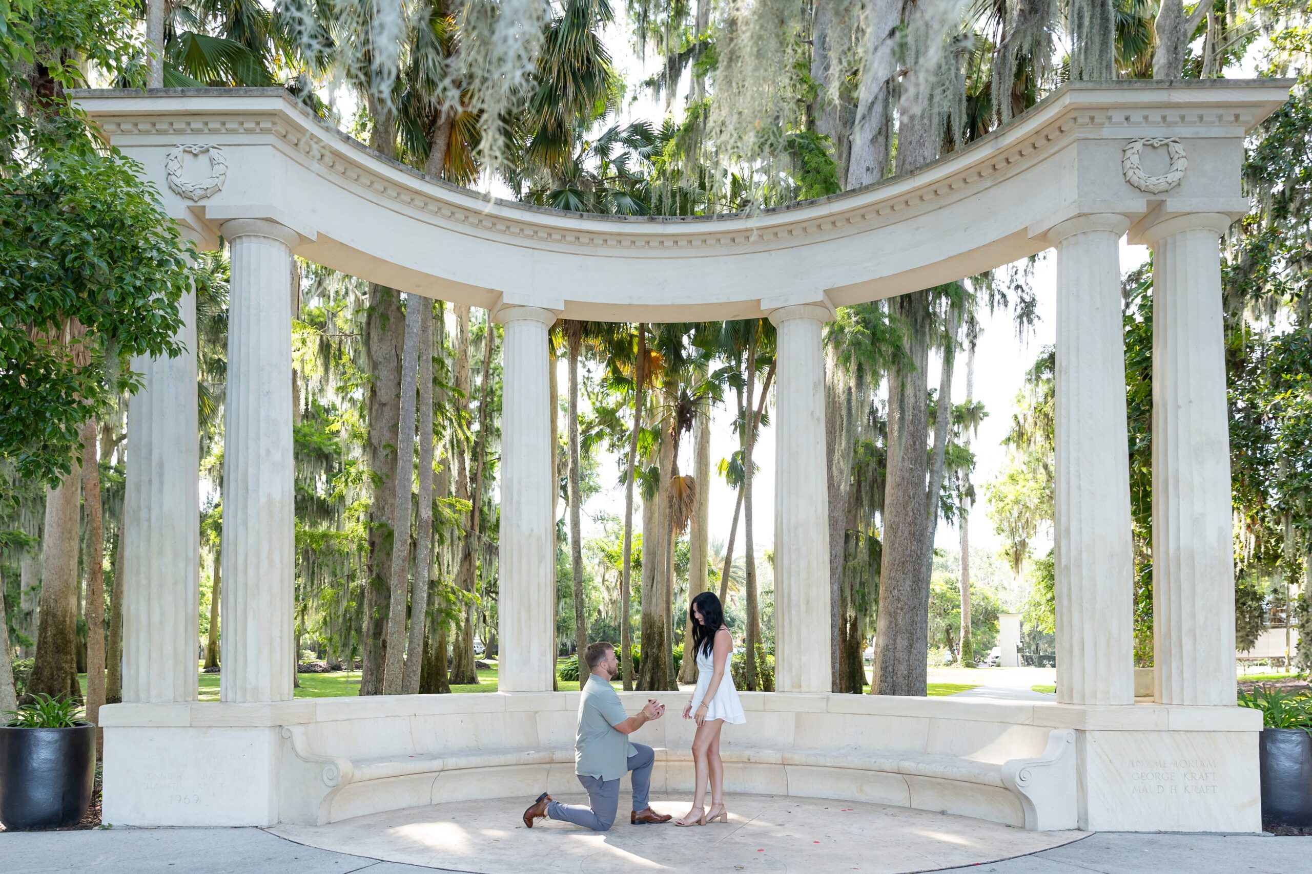 Guy proposes to girl in front of columns at Kraft Azalea Park in Winter Park, Orlando, Florida