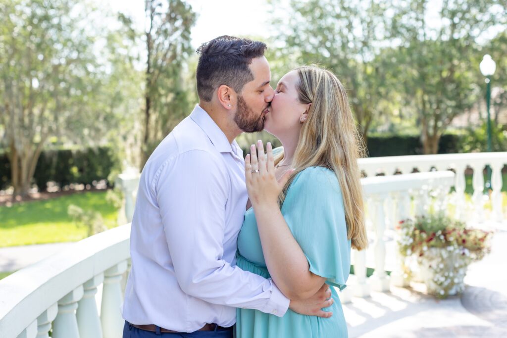 Couple shows ring and kisses after their Proposal at Leu Gardens in Orlando Florida