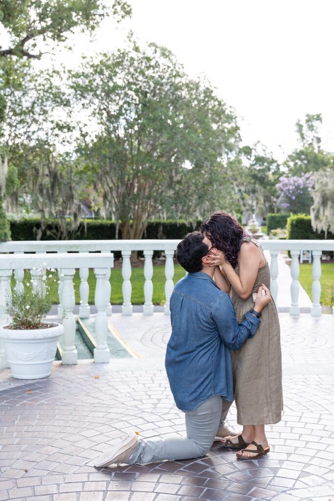 Guy proposes to girl in front of rose garden for their proposal photos at Leu Gardens in Orlando, Florida