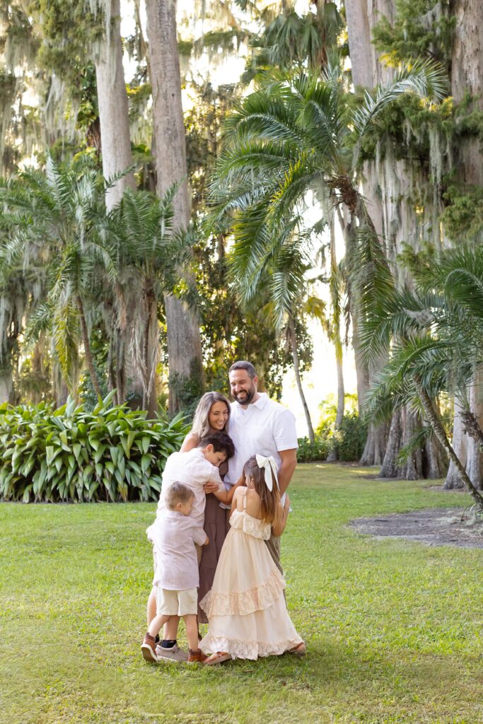 Family hugs each other for their Kraft Azalea Gardens Family Photo Session in Winter Park, Florida