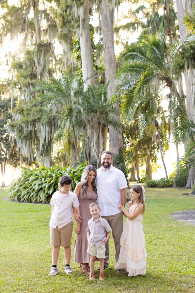Family smiles at each other for their Kraft Azalea Gardens Family Photo Session in Winter Park, Florida