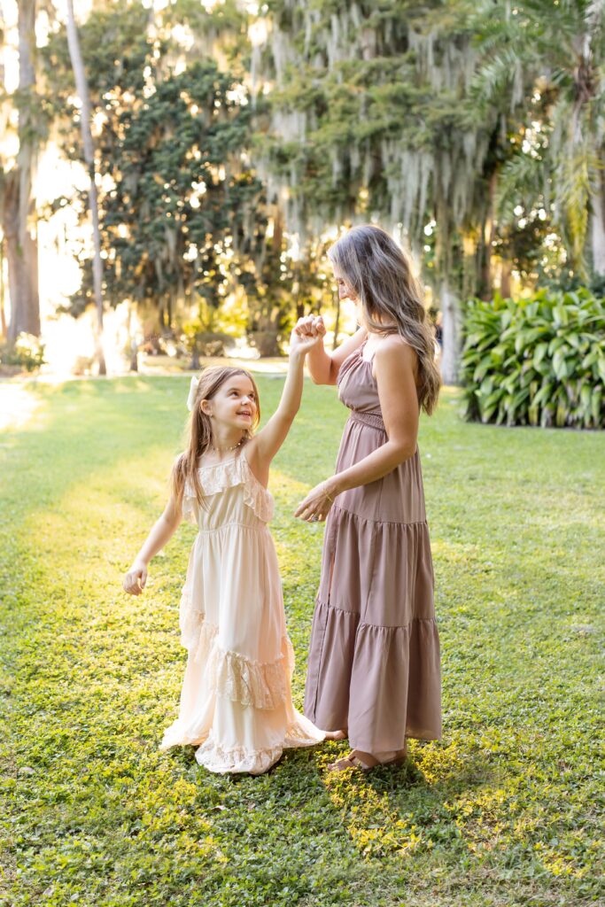 Mother twirls daughter for their Kraft Azalea Gardens Family Photo Session in Winter Park, Florida