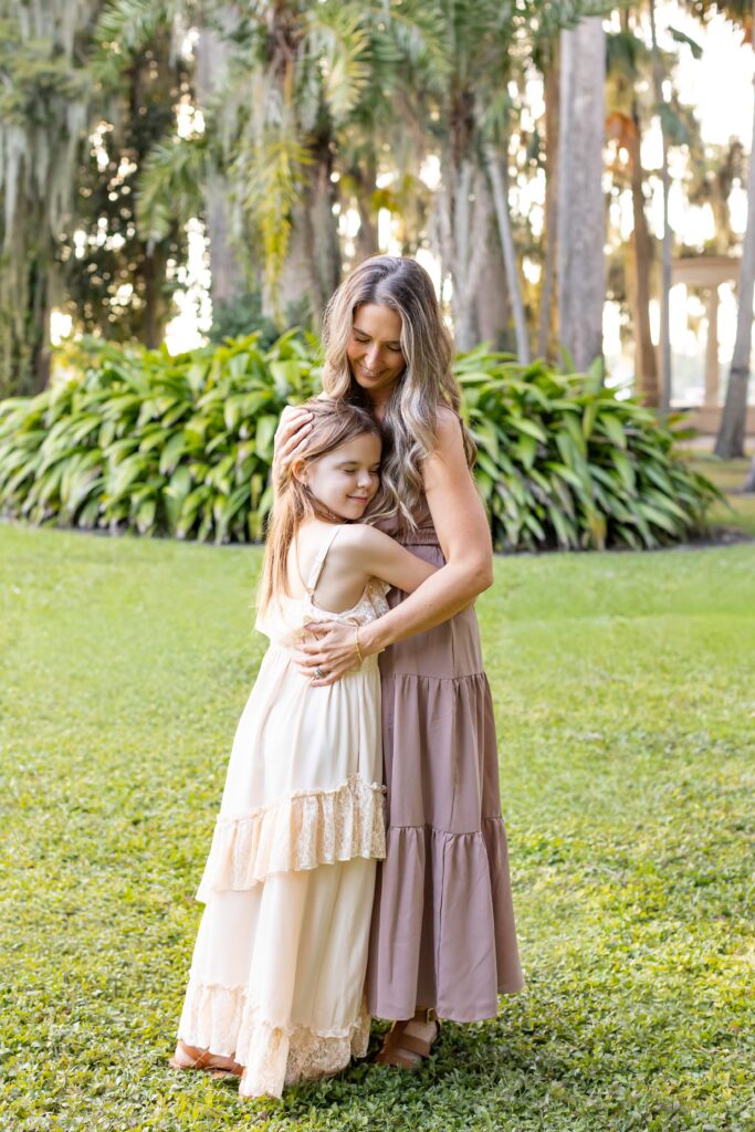 Mother hugs daughter for their Kraft Azalea Gardens Family Photo Session in Winter Park, Florida