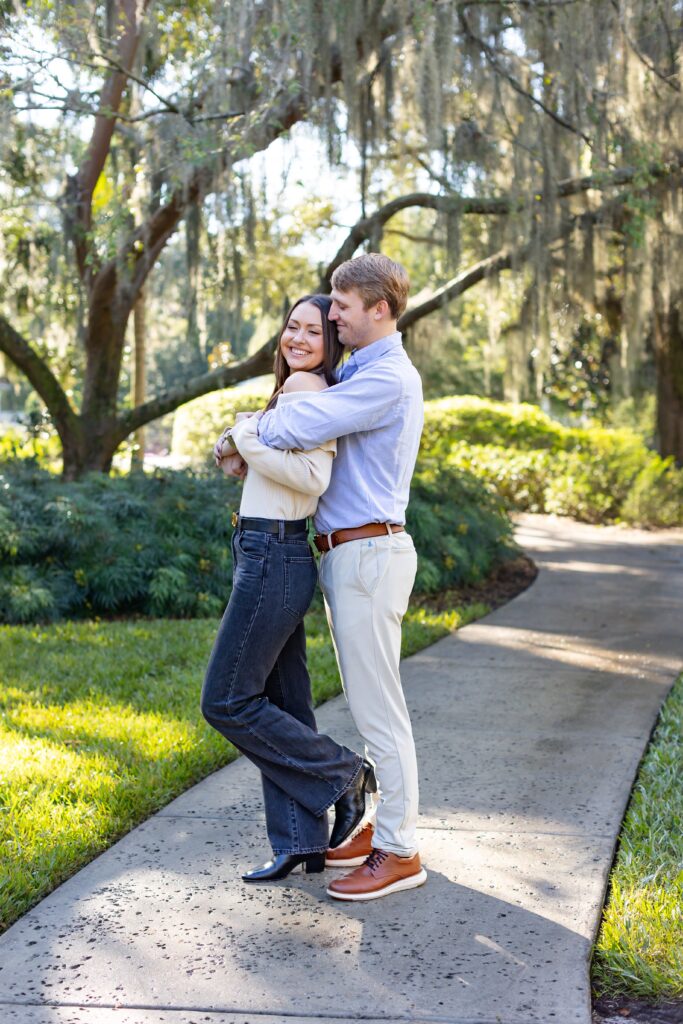 Couple hugs after their proposal in Orlando at Leu Gardens for their engagement photos