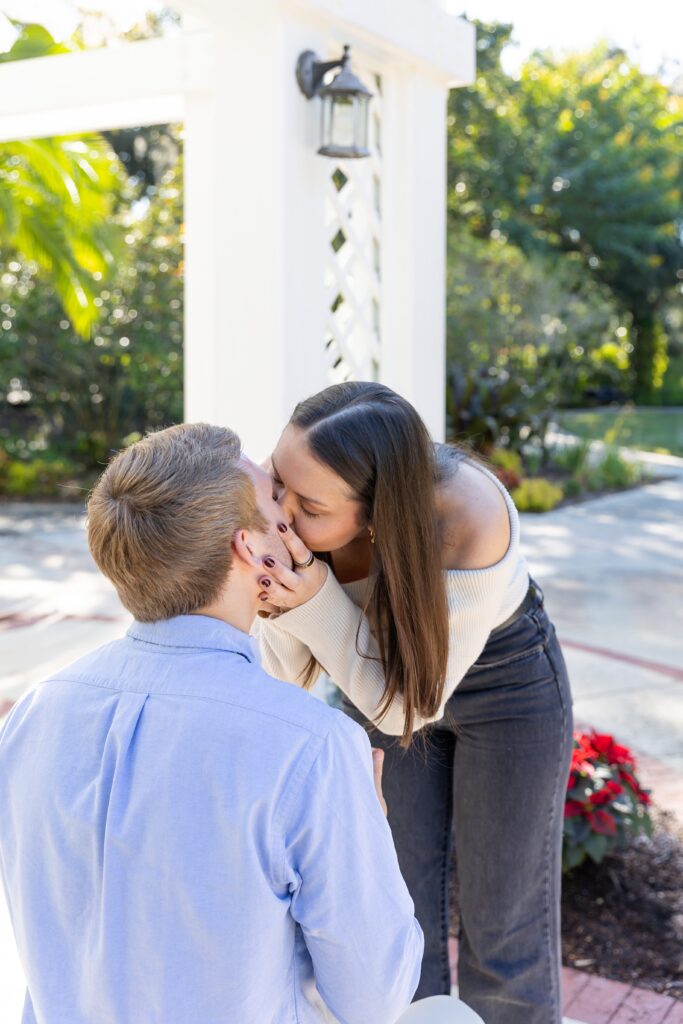 Guy gets down on one knee to for his proposal in Orlando at the idea garden at Leu Gardens