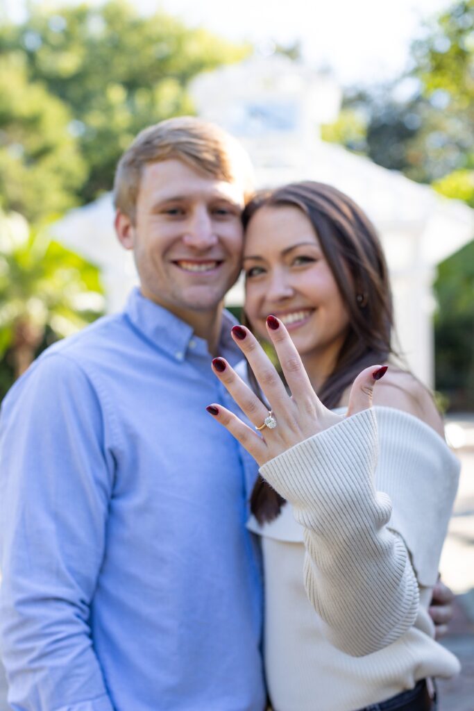 Girl shows off ring after her proposal in Orlando at the idea garden at Leu Gardens