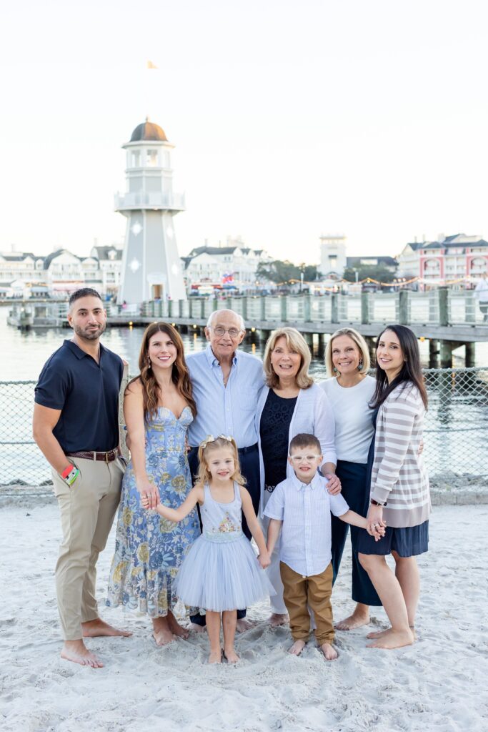 Family holds hands and smiles at Beach Club at Disney Resort in Orlando Florida