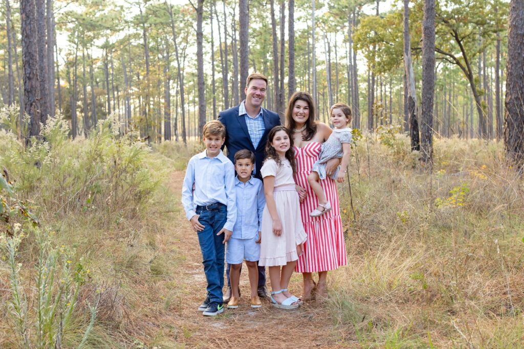 Family poses in field at Wekiva Springs State Park for their family photo session