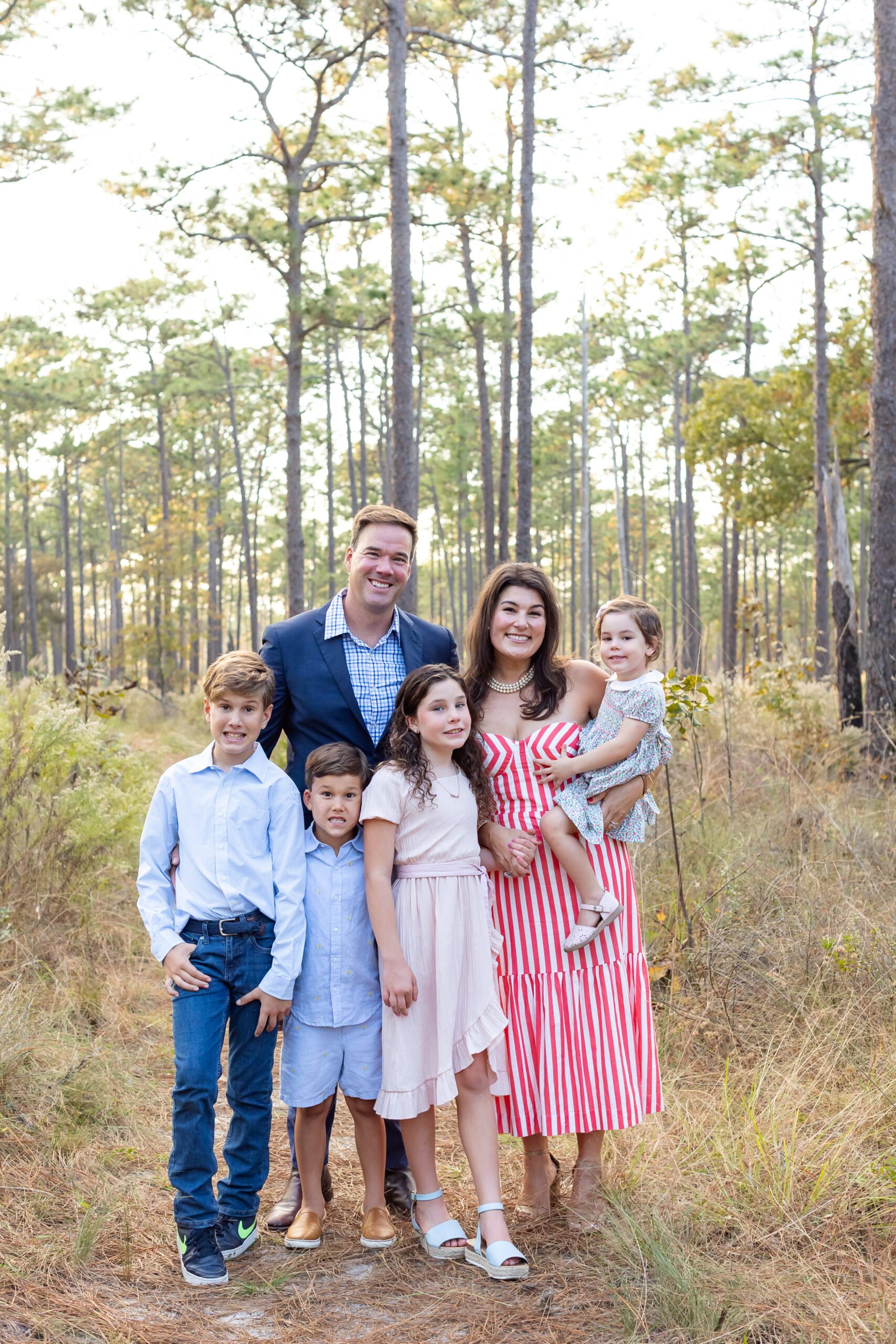 Family poses in field at Wekiva Springs State Park for their family photo session