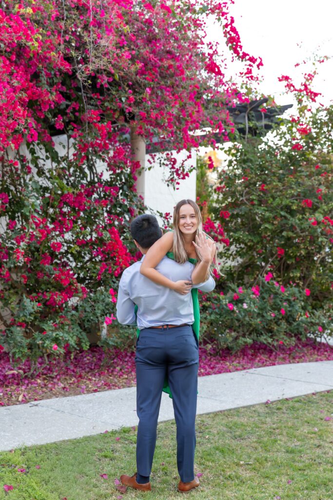 Guy lifts girl as she shows off ring after their proposal at Alfond Inn Winter Park, Florida for their Orlando Proposal