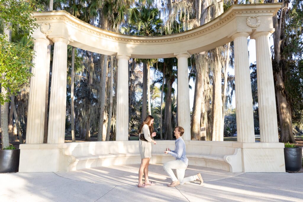 Guy proposes to girl in front of columns at Kraft Azalea Park in Winter Park, Florida